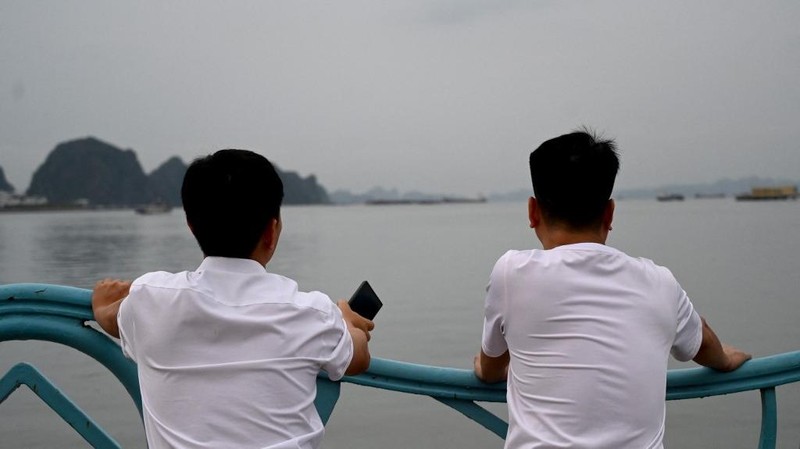 Sebuah kapal yang membawa wisatawan di sekitar Teluk Ha Long, Vietnam, terbalik akibat badai. Media pemerintah melaporkan sebanyak 34 orang ditanyakan tewas. Minggu (20/7/2025). (AFP/NHAC NGUYEN)
