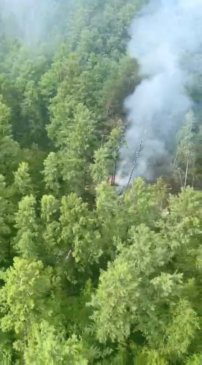 RUSSIA-AIRPLANE/CRASH SITE Smoke rises at the crash site of an Angara Airlines An-24 passenger plane near Tynda in the Amur Region, Russia July 24, 2025, in this still image taken from video. Federal Air Transport Agency/Handout via REUTERS ATTENTION EDITORS - THIS IMAGE HAS BEEN SUPPLIED BY A THIRD PARTY. NO RESALES. NO ARCHIVES. MANDATORY CREDIT.