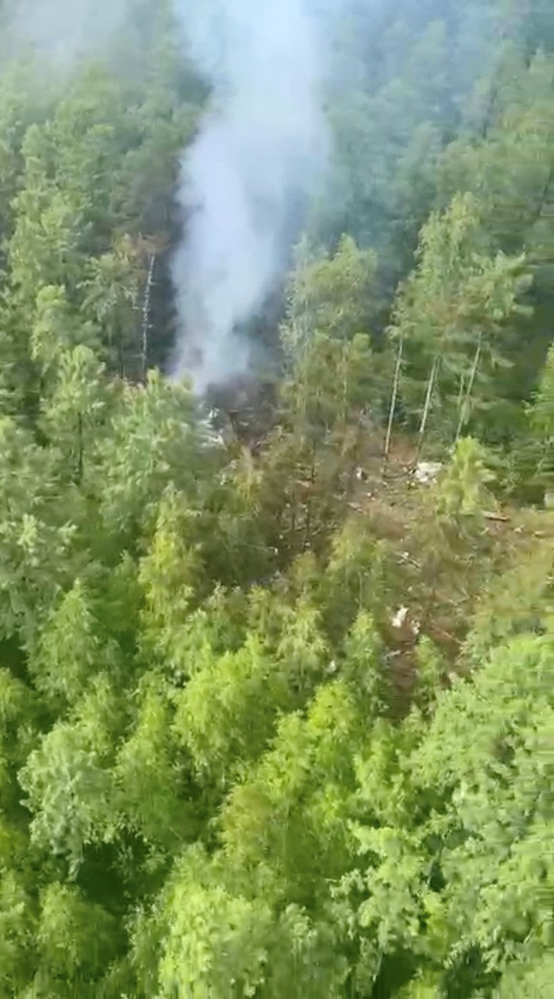 RUSSIA-AIRPLANE/CRASH SITE Smoke rises at the crash site of an Angara Airlines An-24 passenger plane near Tynda in the Amur Region, Russia July 24, 2025, in this still image taken from video. Federal Air Transport Agency/Handout via REUTERS ATTENTION EDITORS - THIS IMAGE HAS BEEN SUPPLIED BY A THIRD PARTY. NO RESALES. NO ARCHIVES. MANDATORY CREDIT.