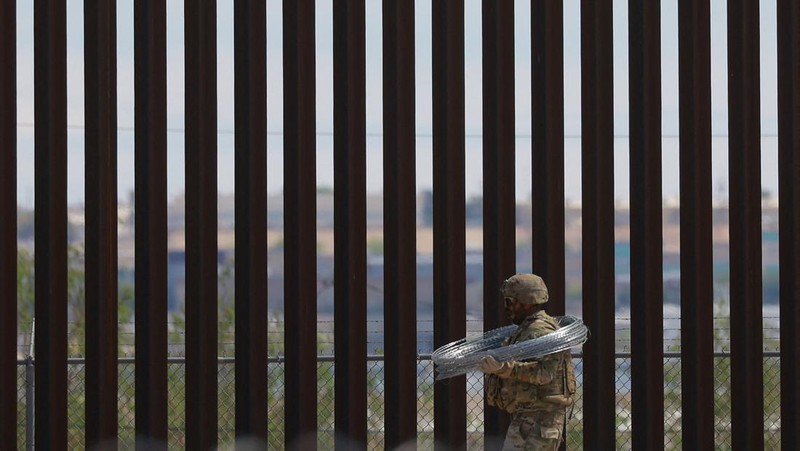 Insinyur tempur Angkatan Darat AS memasang kawat berduri di tembok perbatasan AS-Meksiko untuk memperkuat keamanan di El Paso Texas, seperti yang terlihat dari Ciudad Juarez, Meksiko, 23 Juli 2025. (REUTERS/Jose Luis Gonzalez)