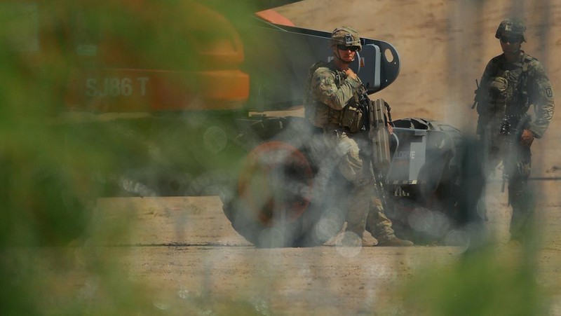 Insinyur tempur Angkatan Darat AS memasang kawat berduri di tembok perbatasan AS-Meksiko untuk memperkuat keamanan di El Paso Texas, seperti yang terlihat dari Ciudad Juarez, Meksiko, 23 Juli 2025. (REUTERS/Jose Luis Gonzalez)