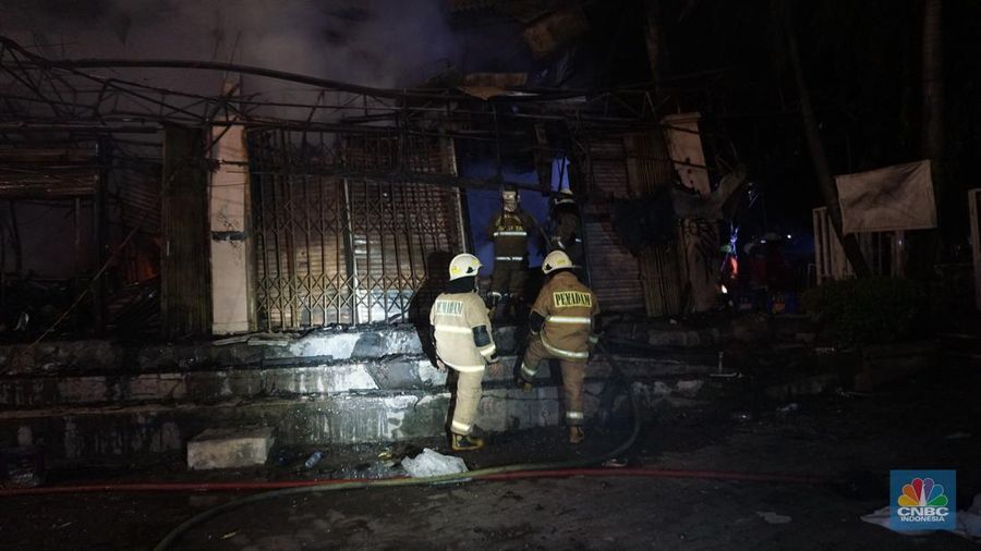 Kobaran api dan asap masih terlihat di Pasar Taman Puring, Kebayoran Baru, Jakarta Selatan, Senin (28/7/2025). Petugas Damkar masih berusaha memadamkan si jago merah. (CNBC Indonesia/Muhammad Sabki)