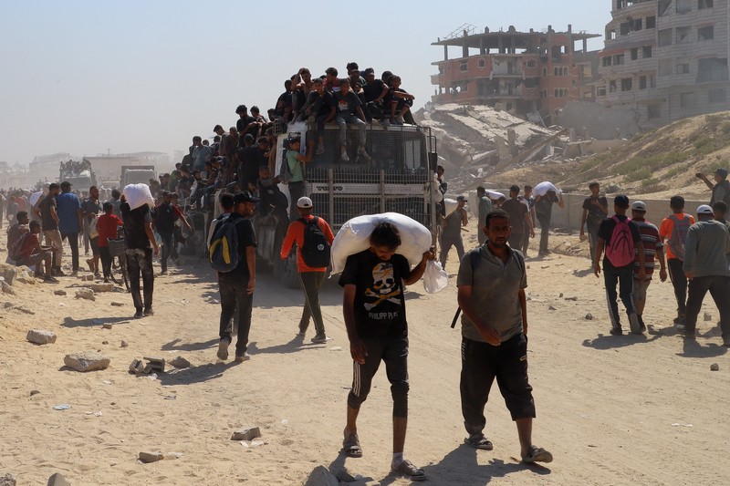 Warga Palestina berkumpul saat mencari bantuan yang masuk ke Gaza melalui Israel, di Beit Lahia, Jalur Gaza utara, 27 Juli 2025. (REUTERS/Mahmoud Issa)