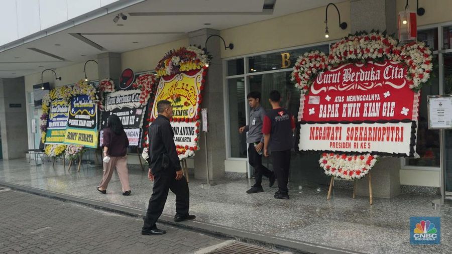 Pekerja membawa karangan bunga di Rumah Duka Sentosa tempat mantan Menteri Koordinator Bidang Perekonomian, Kwik Kian Gie disemayamkan, RSPAD Gatot Subroto, Jakarta Pusat, Selasa (29/7/2025). (CNBC Indonesia/Muhammad Sabki)
