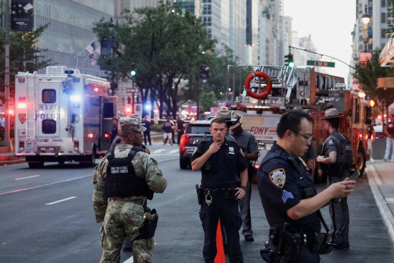 Anggota media berjalan melewati kendaraan layanan darurat di dekat lokasi kejadian penembakan yang dilaporkan di wilayah Manhattan, New York City, AS, 28 Juli 2025. Anggota media berjalan melewati kendaraan layanan darurat di dekat lokasi kejadian penembakan yang dilaporkan di wilayah Manhattan, New York City, AS, 28 Juli 2025. (REUTERS/Bing Guan)