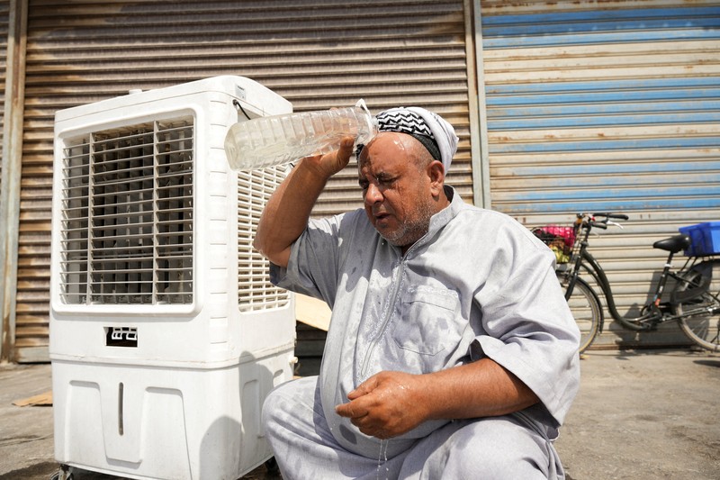 Seorang pria mendinginkan wajahnya dengan kabut air dari alat penyiram selama gelombang panas di Baghdad, Irak, 28 Juli 2025. Seorang pria mendinginkan wajahnya dengan kabut air dari alat penyiram selama gelombang panas di Baghdad, Irak, 28 Juli 2025. (REUTERS/Ahmed Saad)