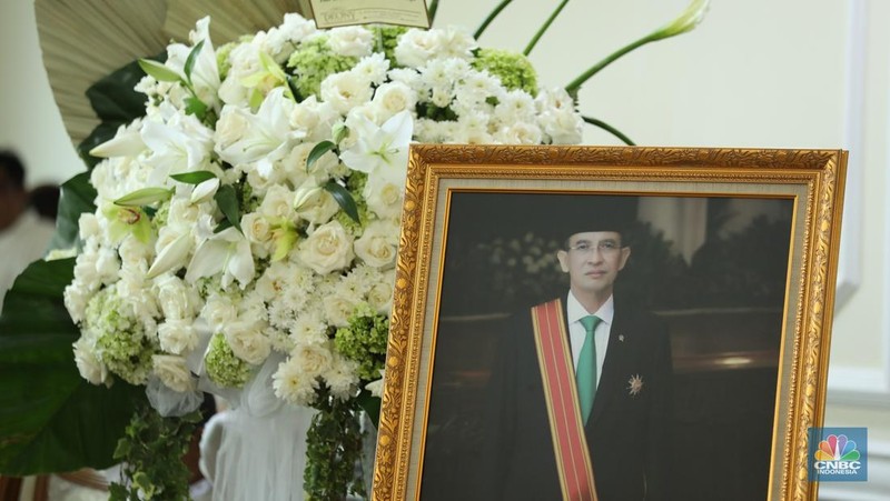 Petugas menata karangan bunga di kediaman almarhum Suryadharma Ali di Jl. Cipinang Cempedak I No.30, Cipinang Cempedak, Kecamatan Jatinegara, Kota Jakarta Timur, Kamis (31/7/2025). (CNBC Indonesia/Tri Susilo)