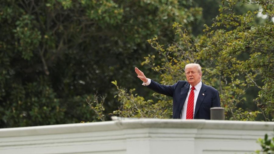 U.S. President Donald Trump gestures as he jokes to reporters that he's planning to install nuclear missiles, on a with an architect and aides on the roof of the White House in Washington, D.C., U.S., August 5, 2025. REUTERS/Jonathan Ernst