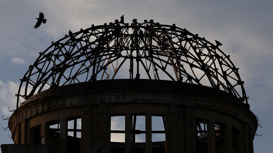A crow flies over the dome, a day ahead of the 80th anniversary of the World War Two atomic bombing in Hiroshima, western Japan, August 5, 2025. REUTERS/Kim Kyung-Hoon     TPX IMAGES OF THE DAY