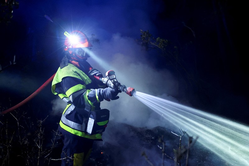 Trees burn during a wildfire near in Saint-Laurent-de-la-Cabrerisse, southern France, August 6, 2025. REUTERS/Abdul Saboor