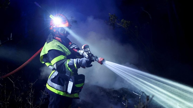 Trees burn during a wildfire near in Saint-Laurent-de-la-Cabrerisse, southern France, August 6, 2025. REUTERS/Abdul Saboor