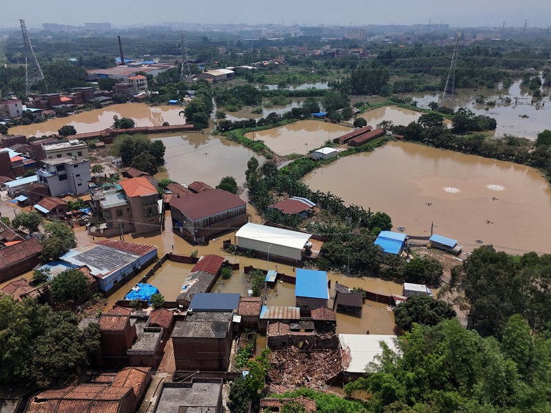 ASIA-WEATHER/CHINA A drone view shows a house that partially collapsed after days of heavy rainfall, at a flooded section of the village in Qingyuan, Guangdong province, China August 8, 2025. REUTERS/Florence Lo