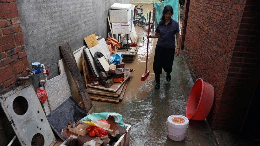 A drone view shows a house that partially collapsed after days of heavy rainfall, at a flooded section of the village in Qingyuan, Guangdong province, China August 8, 2025. REUTERS/Florence Lo