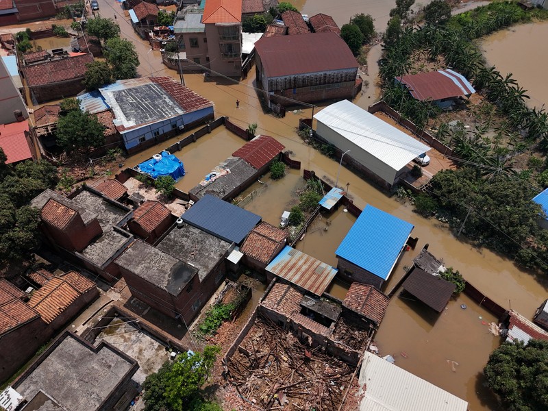 ASIA-WEATHER/CHINA A drone view shows a house that partially collapsed after days of heavy rainfall, at a flooded section of the village in Qingyuan, Guangdong province, China August 8, 2025. REUTERS/Florence Lo