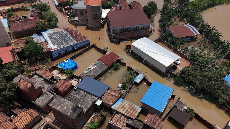 A drone view shows a house that partially collapsed after days of heavy rainfall, at a flooded section of the village in Qingyuan, Guangdong province, China August 8, 2025. REUTERS/Florence Lo