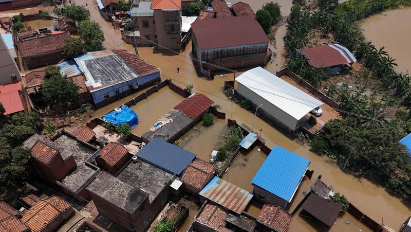 A drone view shows a house that partially collapsed after days of heavy rainfall, at a flooded section of the village in Qingyuan, Guangdong province, China August 8, 2025. REUTERS/Florence Lo