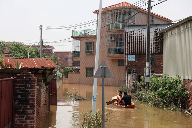 ASIA-WEATHER/CHINA A drone view shows a house that partially collapsed after days of heavy rainfall, at a flooded section of the village in Qingyuan, Guangdong province, China August 8, 2025. REUTERS/Florence Lo