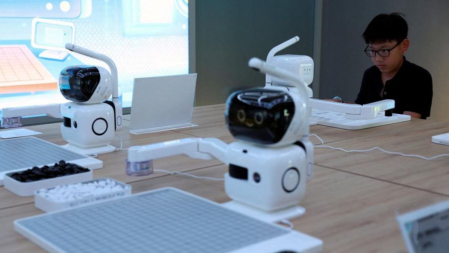A staff member works at a section selling Robot World merchandise, during an organised media tour to Robot Mall, a store selling humanoid and other robots, in Beijing, China August 6, 2025. REUTERS/Florence Lo