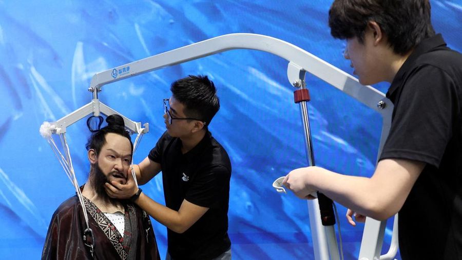 A staff member works at a section selling Robot World merchandise, during an organised media tour to Robot Mall, a store selling humanoid and other robots, in Beijing, China August 6, 2025. REUTERS/Florence Lo