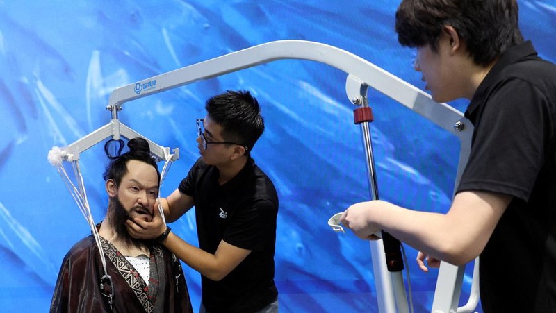 A staff member works at a section selling Robot World merchandise, during an organised media tour to Robot Mall, a store selling humanoid and other robots, in Beijing, China August 6, 2025. REUTERS/Florence Lo