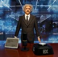 A humanoid robot in the likeness of late physicist Albert Einstein stands behind a price tag, during an organised media tour to Robot Mall, a store selling humanoid and other robots, in Beijing, China August 6, 2025. REUTERS/Florence Lo