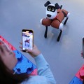 Media members film a Baby Alpha robot dog during an organised media tour to Robot Mall, a store selling humanoid and other robots, in Beijing, China August 6, 2025. REUTERS/Florence Lo     TPX IMAGES OF THE DAY