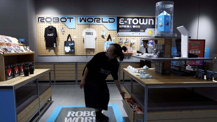 A staff member works at a section selling Robot World merchandise, during an organised media tour to Robot Mall, a store selling humanoid and other robots, in Beijing, China August 6, 2025. REUTERS/Florence Lo