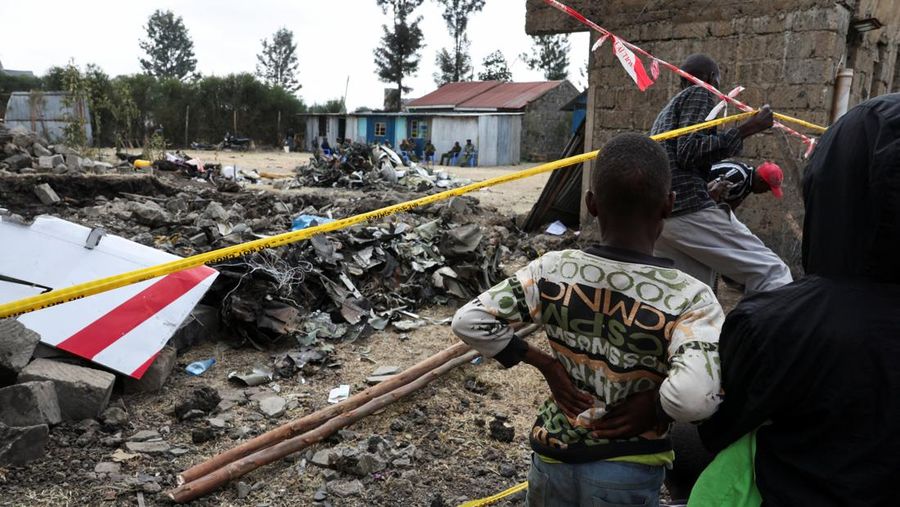 Police officers carry the wreckage at the scene where a Cessna plane operated by AMREF Flying Doctors crashed into buildings in the Githurai suburb of northeastern Nairobi, Kenya, August 8, 2025. The aircraft, carrying medical staff, was en route to Hargeisa, the capital of Somalia's breakaway territory of Somaliland. REUTERS/Monicah Mwangi
