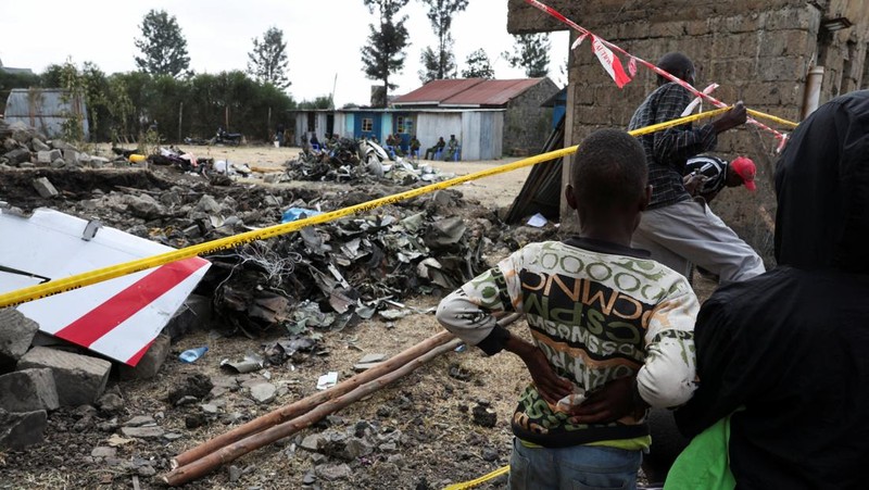 Police officers carry the wreckage at the scene where a Cessna plane operated by AMREF Flying Doctors crashed into buildings in the Githurai suburb of northeastern Nairobi, Kenya, August 8, 2025. The aircraft, carrying medical staff, was en route to Hargeisa, the capital of Somalia's breakaway territory of Somaliland. REUTERS/Monicah Mwangi