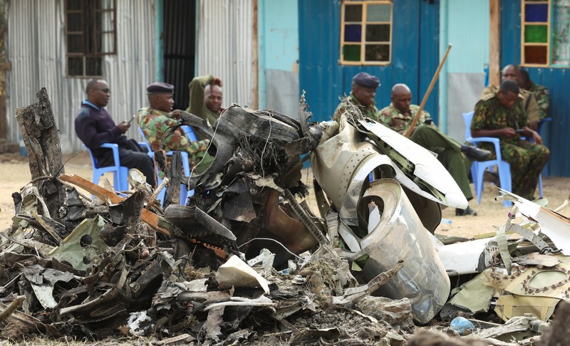 KENYA-CRASH/ Police officers carry the wreckage at the scene where a Cessna plane operated by AMREF Flying Doctors crashed into buildings in the Githurai suburb of northeastern Nairobi, Kenya, August 8, 2025. The aircraft, carrying medical staff, was en route to Hargeisa, the capital of Somalia's breakaway territory of Somaliland. REUTERS/Monicah Mwangi