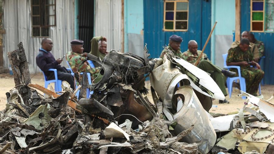 Police officers carry the wreckage at the scene where a Cessna plane operated by AMREF Flying Doctors crashed into buildings in the Githurai suburb of northeastern Nairobi, Kenya, August 8, 2025. The aircraft, carrying medical staff, was en route to Hargeisa, the capital of Somalia's breakaway territory of Somaliland. REUTERS/Monicah Mwangi