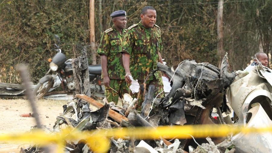 Police officers carry the wreckage at the scene where a Cessna plane operated by AMREF Flying Doctors crashed into buildings in the Githurai suburb of northeastern Nairobi, Kenya, August 8, 2025. The aircraft, carrying medical staff, was en route to Hargeisa, the capital of Somalia's breakaway territory of Somaliland. REUTERS/Monicah Mwangi