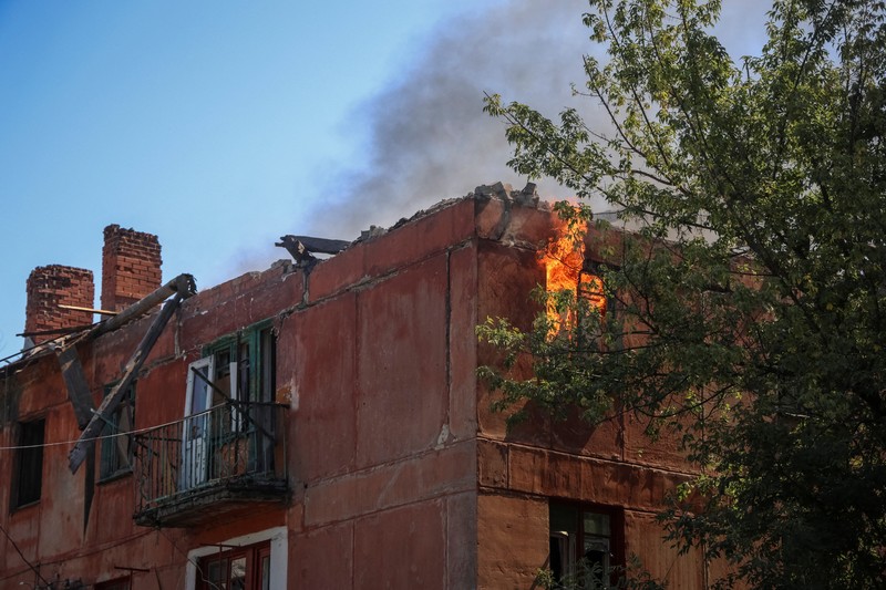 Fire burns in a flat of an apartment building hit by Russian drone strike, amid Russia's attack on Ukraine, in the town of Bilozerske in Donetsk region, Ukraine August 10, 2025. REUTERS/Oleksandr Ratushniak     TPX IMAGES OF THE DAY