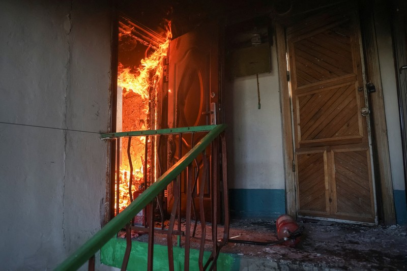 Fire burns in a flat of an apartment building hit by Russian drone strike, amid Russia's attack on Ukraine, in the town of Bilozerske in Donetsk region, Ukraine August 10, 2025. REUTERS/Oleksandr Ratushniak     TPX IMAGES OF THE DAY