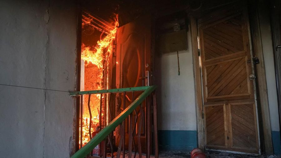 Fire burns in a flat of an apartment building hit by Russian drone strike, amid Russia's attack on Ukraine, in the town of Bilozerske in Donetsk region, Ukraine August 10, 2025. REUTERS/Oleksandr Ratushniak     TPX IMAGES OF THE DAY