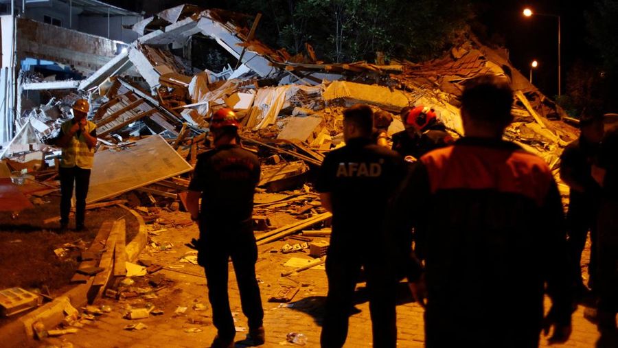 Orang-orang bergegas ke bangunan yang runtuh untuk mencari korban selamat setelah gempa bumi di Sindirgi di provinsi Balikesir barat, Turki, 10 Agustus 2025. (Ihlas News Agency (IHA) via REUTERS ATTENTION EDITORS)
