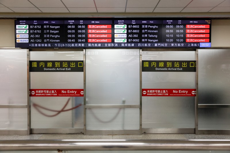 ASIA-WEATHER/TAIWAN A screen displays information on cancelled domestic flights, as Typhoon Podul approaches the country, in Taipei, Taiwan August 13, 2025. REUTERS/Ann Wang