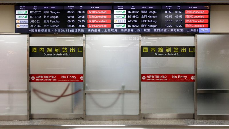 A screen displays information on cancelled domestic flights, as Typhoon Podul approaches the country, in Taipei, Taiwan August 13, 2025. REUTERS/Ann Wang