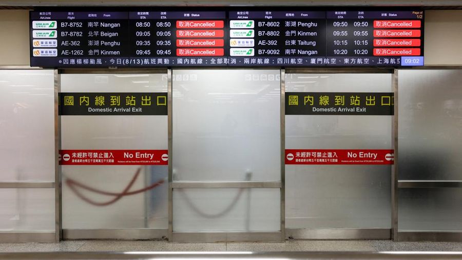 ASIA-WEATHER/TAIWAN A screen displays information on cancelled domestic flights, as Typhoon Podul approaches the country, in Taipei, Taiwan August 13, 2025. REUTERS/Ann Wang