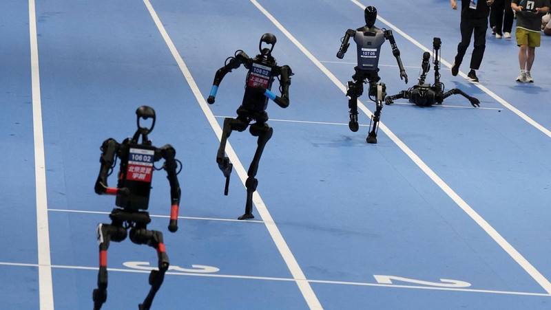Unitree Robotics and Tiangong humanoid robots compete in the 100m final at the inaugural World Humanoid Robot Games, at the National Speed Skating Oval in Beijing, China August 17, 2025.  REUTERS/Florence Lo     TPX IMAGES OF THE DAY