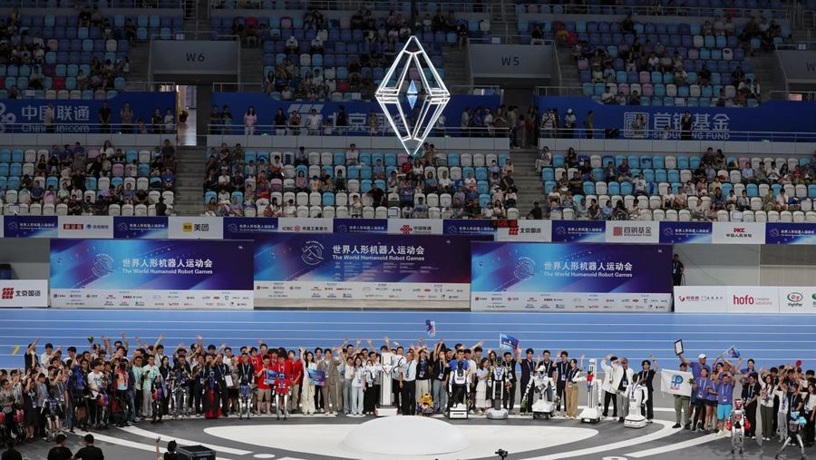 Unitree Robotics and Tiangong humanoid robots compete in the 100m final at the inaugural World Humanoid Robot Games, at the National Speed Skating Oval in Beijing, China August 17, 2025.  REUTERS/Florence Lo     TPX IMAGES OF THE DAY