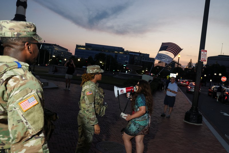USA-TRUMP/CRIME Banners, placed by demonstrators, hang on the White House fence during a protest after U.S. President Donald Trump deployed National Guard and ordered an increased presence of federal law enforcement to assist in crime prevention, in Washington, D.C., U.S., August 16, 2025. REUTERS/Ken Cedeno