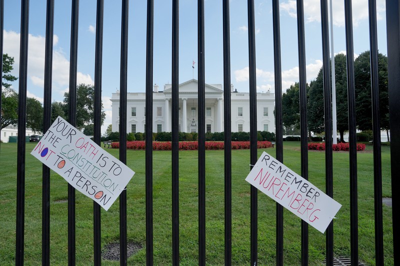 USA-TRUMP/CRIME Banners, placed by demonstrators, hang on the White House fence during a protest after U.S. President Donald Trump deployed National Guard and ordered an increased presence of federal law enforcement to assist in crime prevention, in Washington, D.C., U.S., August 16, 2025. REUTERS/Ken Cedeno