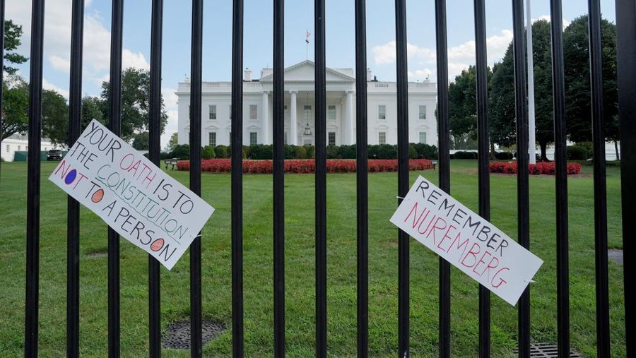 Banners, placed by demonstrators, hang on the White House fence during a protest after U.S. President Donald Trump deployed National Guard and ordered an increased presence of federal law enforcement to assist in crime prevention, in Washington, D.C., U.S., August 16, 2025. REUTERS/Ken Cedeno