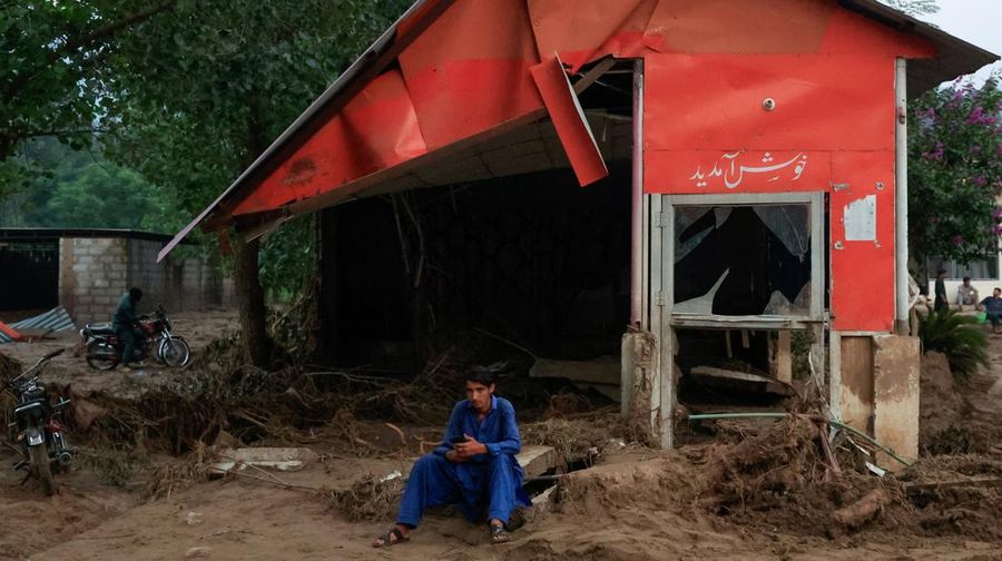 Warga duduk di antara puing-puing rumah yang rusak akibat badai yang menyebabkan hujan lebat dan banjir, di Bayshonai Kalay, distrik Buner, provinsi Khyber Pakhtunkhwa, Pakistan, 17 Agustus 2025. (REUTERS/Akhtar Soomro)