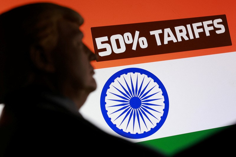 A man reads the latest edition of The Times of India newspaper, with the lead story on U.S. tariffs on most Indian goods, in the old quarters of Delhi, India, August 27, 2025. REUTERS/Anushree Fadnavis