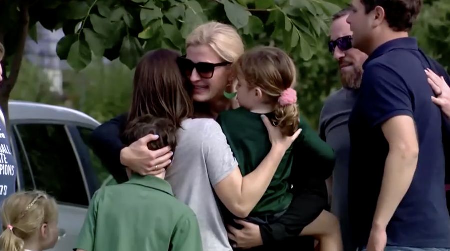 Families and loved ones reunite outside the police barricades after a shooting at Annunciation Church, which is also home to an elementary school, in Minneapolis, Minnesota, U.S. August 27, 2025.  REUTERS/Ben Brewer