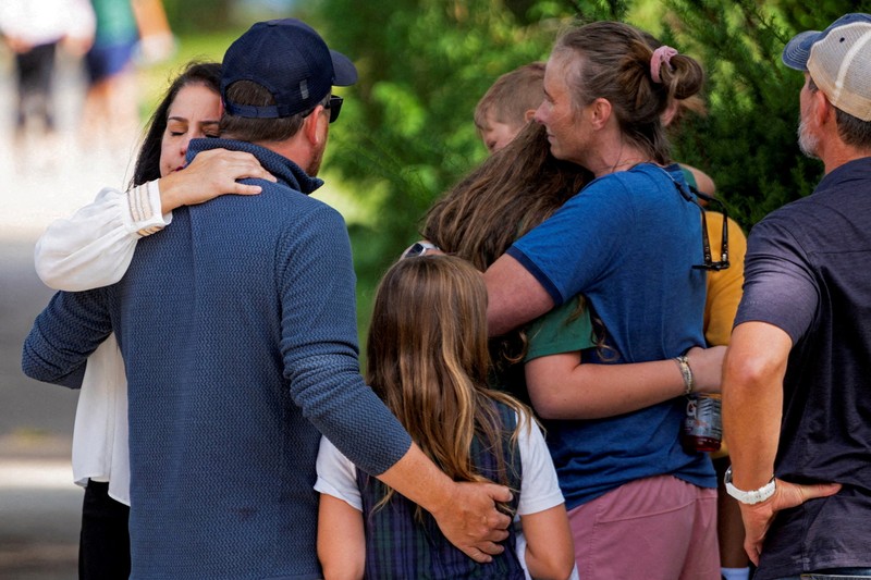 USA-MINNEAPOLIS/SHOOTING Families and loved ones reunite outside the police barricades after a shooting at Annunciation Church, which is also home to an elementary school, in Minneapolis, Minnesota, U.S. August 27, 2025. REUTERS/Ben Brewer
