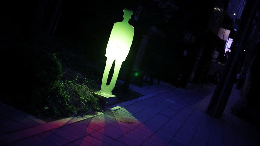 People walk near a life-size holographic police officer installed to prevent crime at a park in Seoul, South Korea, August 28, 2025. REUTERS/Kim Hong-Ji