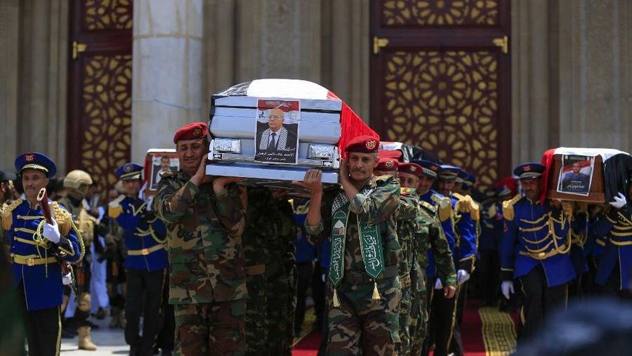 Yemeni honor guard carry the coffins of Prime Minister of Yemen's Houthi-led government Ahmed Ghaleb Al-Rahwi and other officials killed in an Israeli strike days earlier, during a funeral procession in Sanaa on September 1, 2025. Yemen's Huthi rebels held a funeral on September 1 for their prime minister, nine ministers, and two cabinet officials, killed in an Israeli air strike on August 28 as they attended a government meeting in the Sanaa area. (Photo by Mohammed HUWAIS / AFP)